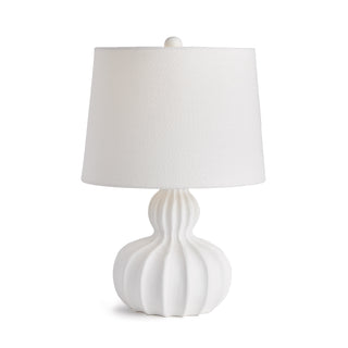 White lamp with solid wavy carved wood base with white shade.