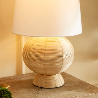 Lamp with cane rattan base and white shade close up